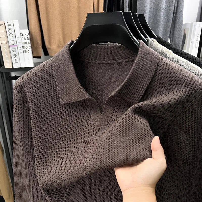 Men's loose green pullover sweater on a hanger, casual autumn wear.