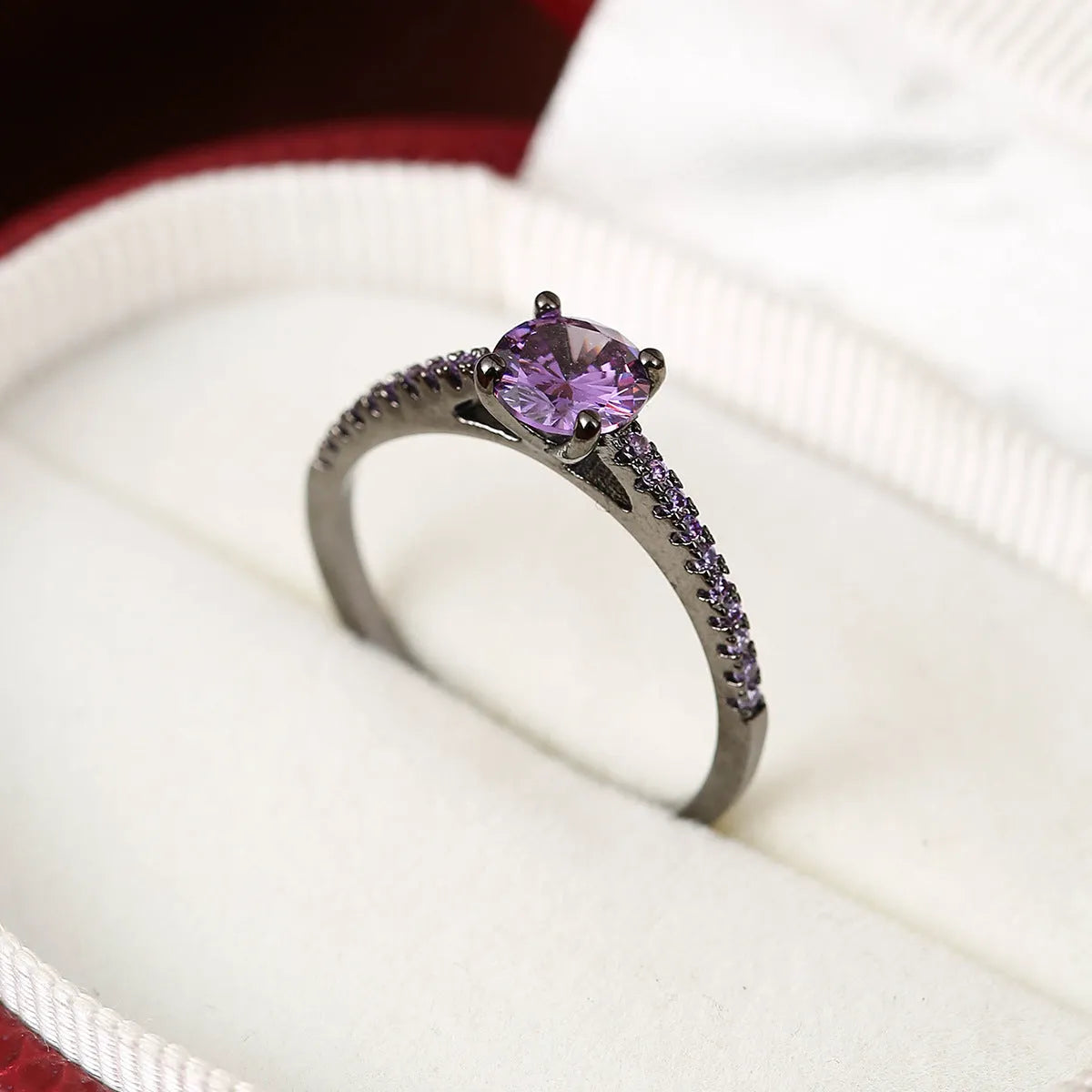 Geometric hexagon copper ring with colourful zircon stones in a metallic electroplated finish.