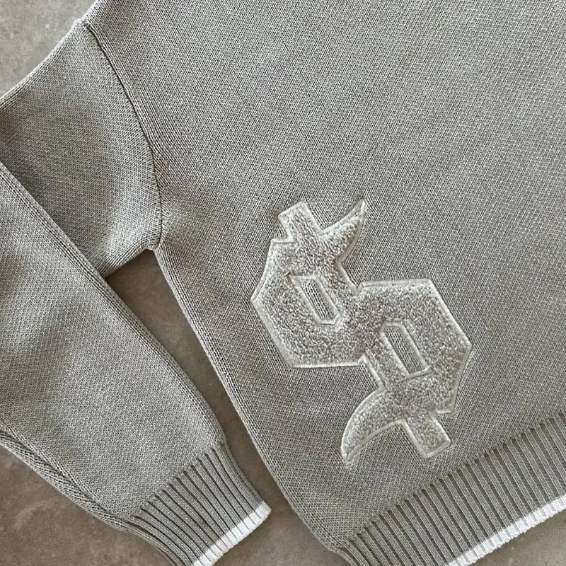 Grey loose-fitting knitwear coat with long sleeves and textured Jacquard weave pattern