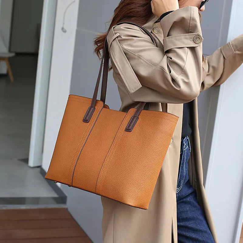 Women's black genuine leather crossbody bag showing internal compartments and horizontal square shape