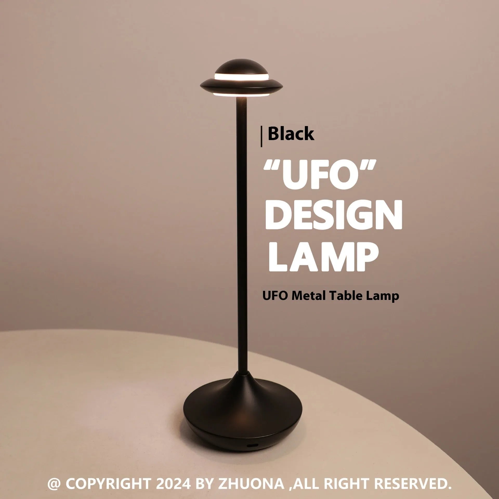 Metallic UFO-shaped desk lamp with touch controls in black finish on wooden surface
