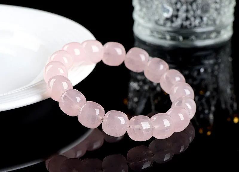 Pink bamboo crystal barrel bead bracelet with geometric 11mm-12mm beads on a wrist.