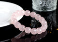 Pink bamboo crystal barrel bead bracelet with geometric 11mm-12mm beads on a wrist.
