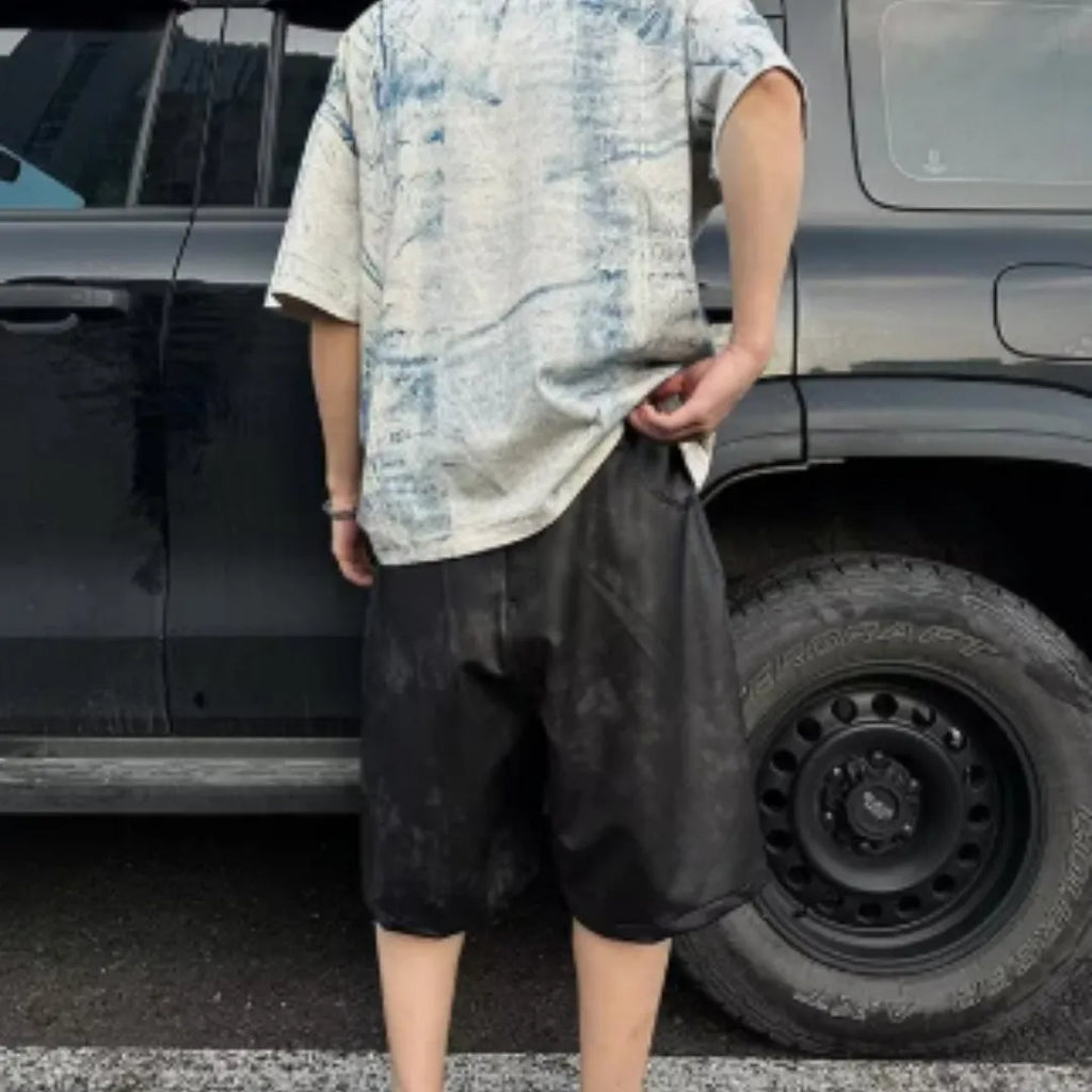 Korean style loose fit T-shirt with a full printed tie dye and dirty painting design on a solid colour background.
