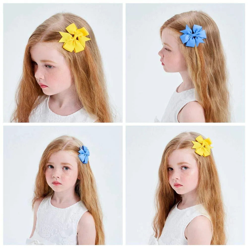 Assorted colours of 3-inch grosgrain ribbon pinwheel hair bows with alligator clips for toddlers.