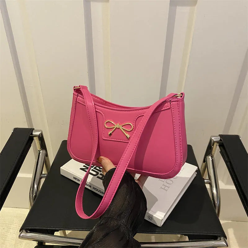 Western style baguette shoulder bag with bow detail showing horizontal square shape