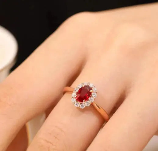 Gold pigeon and floral design sterling silver ring with a red blood gemstone inlay.