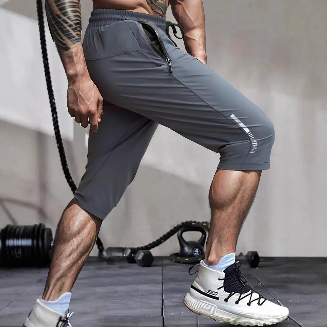Men's cropped quick-dry sports casual pants in nylon, shown in blue colour.