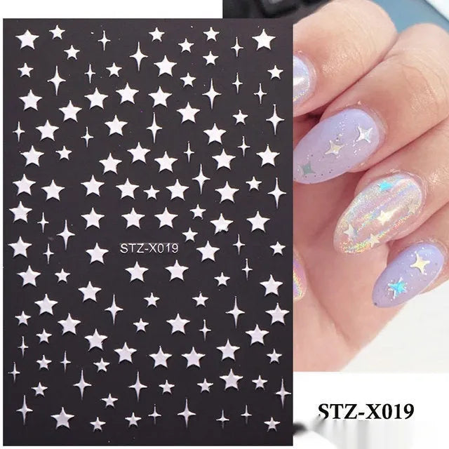 Close-up of a cartoon-style nail sticker with black and silver strips and a love pattern design on a fingernail.