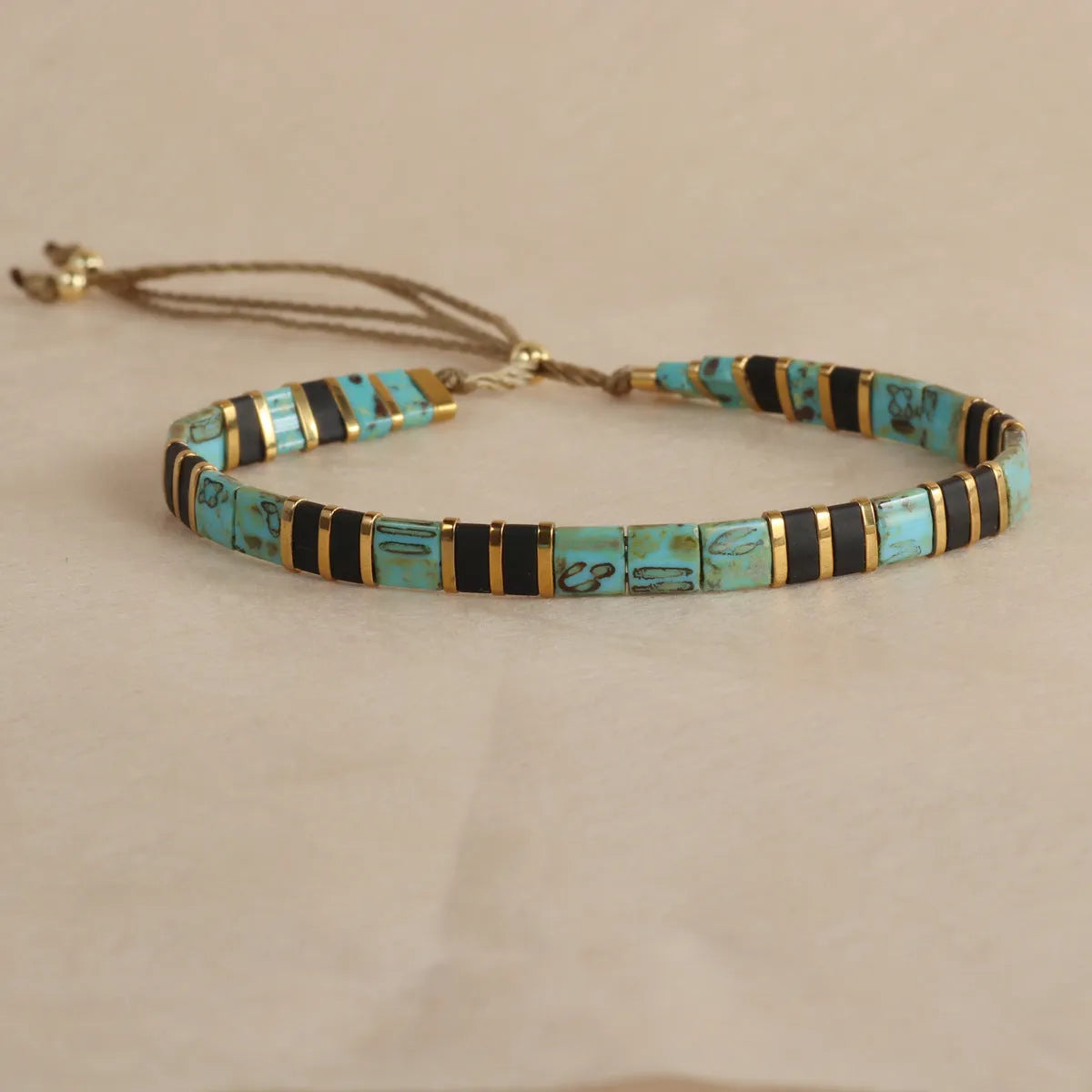 Glass and coloured glaze beaded bracelet with geometric round beads in five colour options