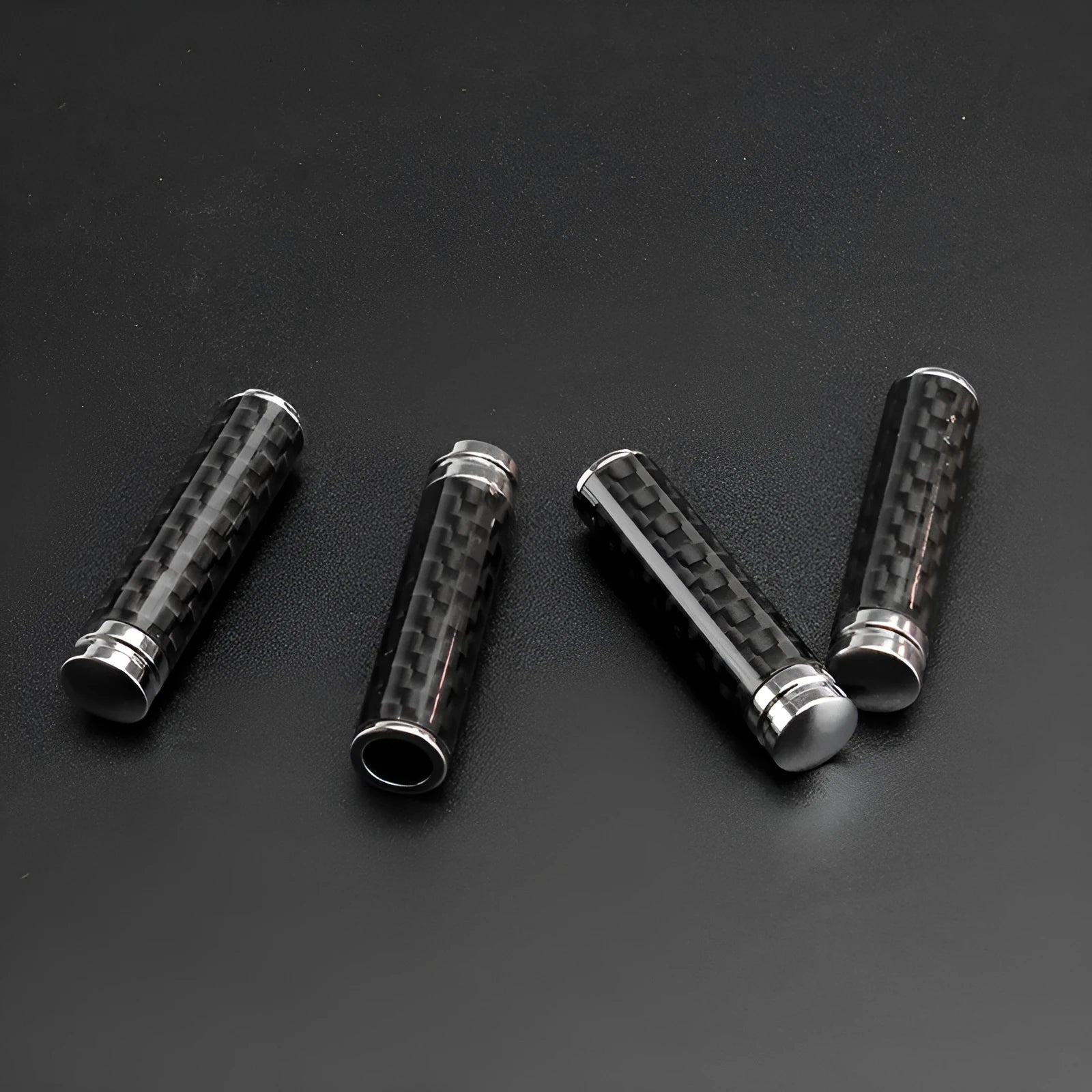 Four carbon fibre and metal car door handle decorative covers for direct replacement installation.