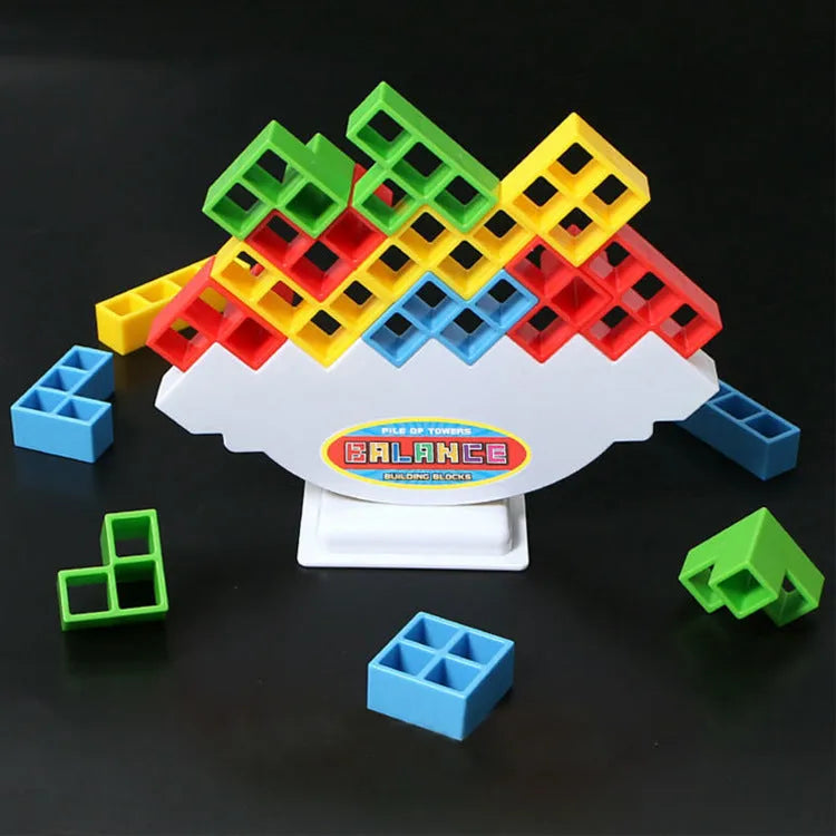 Plastic balance stacking game with 16 coloured blocks, chassis and base on table