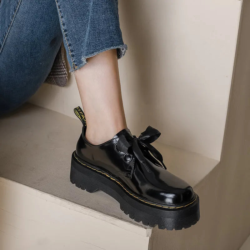 Women's thick soled leather shoes with ribbon and cross strap details in white or black