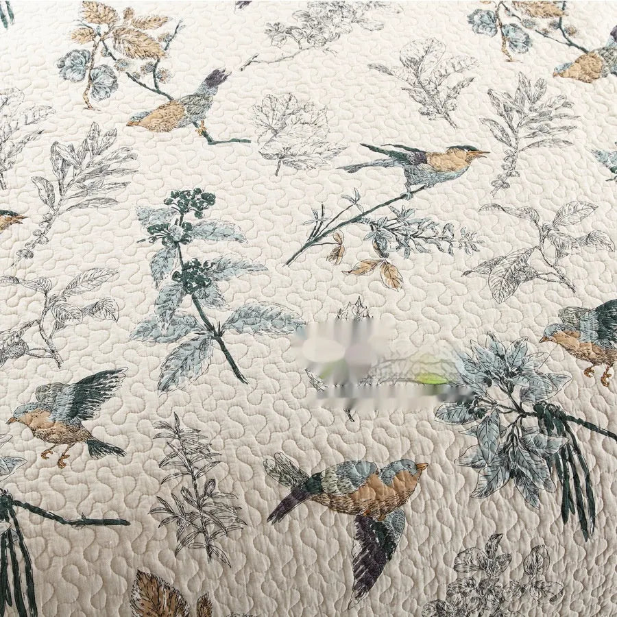 Quilted pure cotton bed cover set with printed pattern on a bed, includes two matching pillowcases.