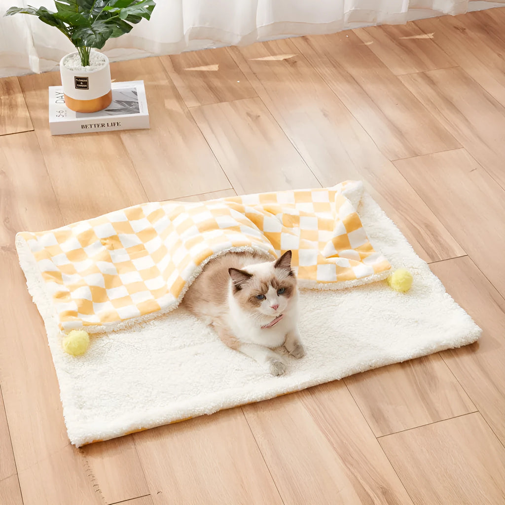 Plush cotton fleece pet blanket with plaid pattern and fur balls in green colour on couch