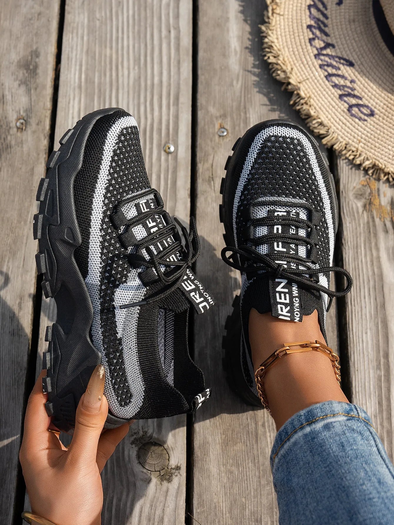 Women's Flyknit mesh lace-up sneaker in a grey colourway, showing the breathable upper and rubber sole.