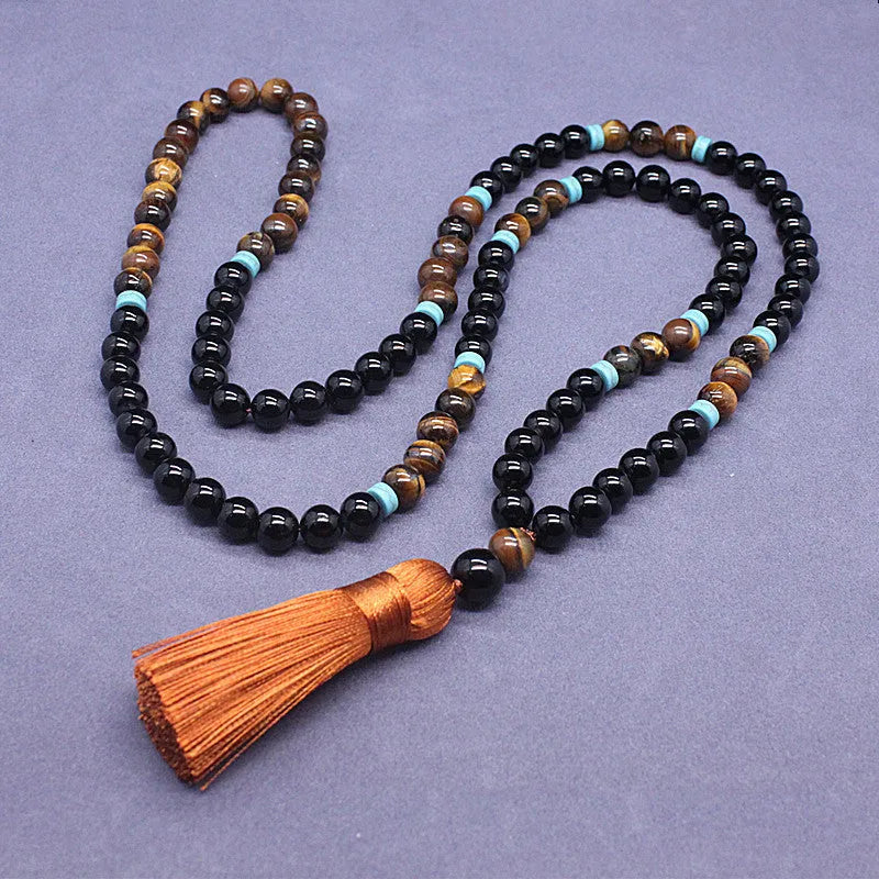 Black geometric agate bracelet and necklace set on a display background.