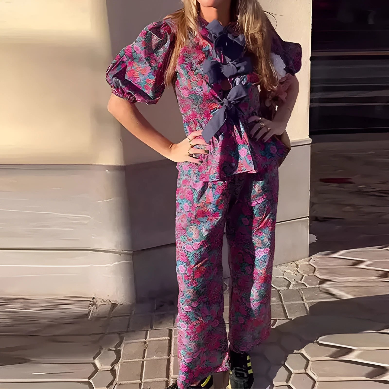 Women's floral print trouser suit set featuring a puff sleeve top with tie-neck and matching trousers.