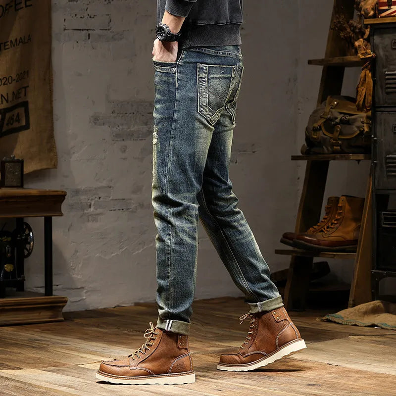 Men's skinny fit retro blue jeans with a zip fly on a grey background