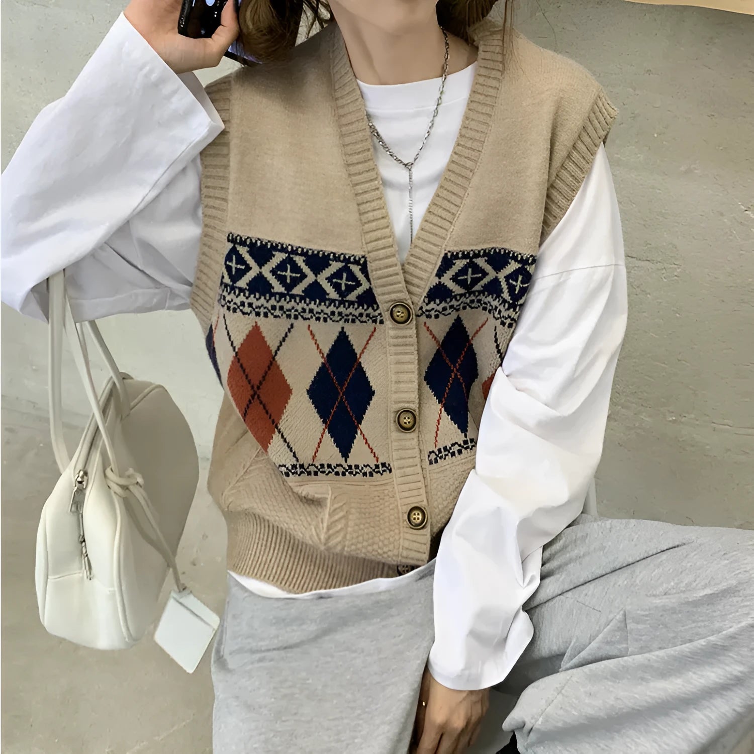 Sleeveless loose cardigan with diamond plaid pattern in khaki colour showing front view