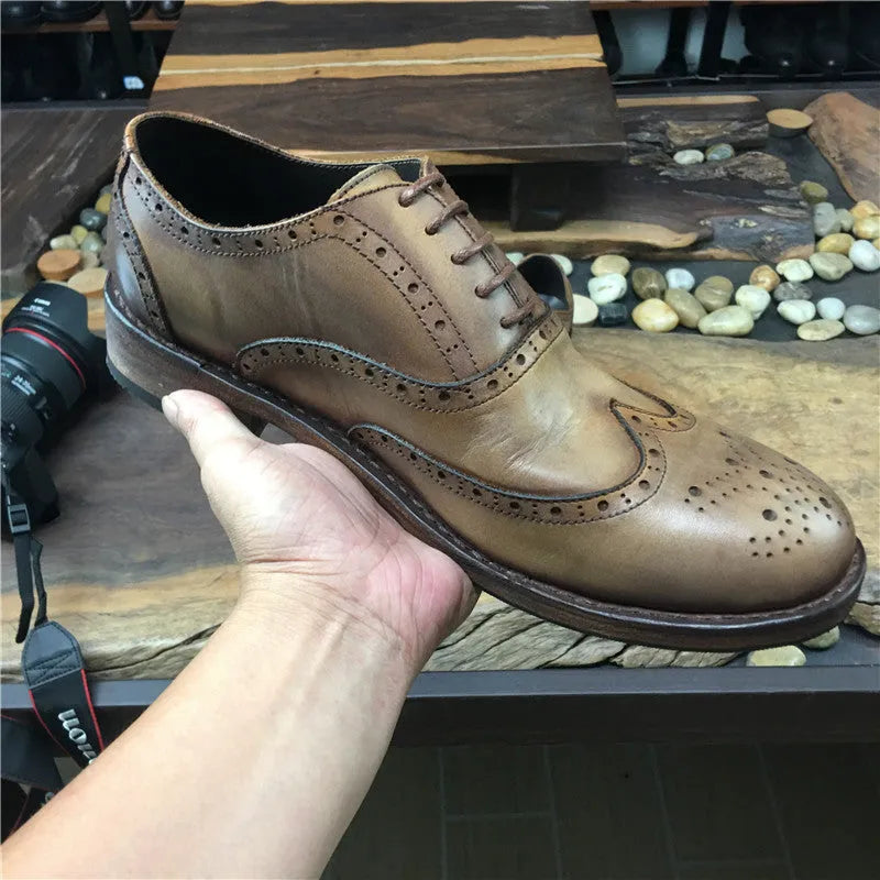 Light brown men's vintage distressed leather shoes with engraved detailing, round toe, and lace-up front.
