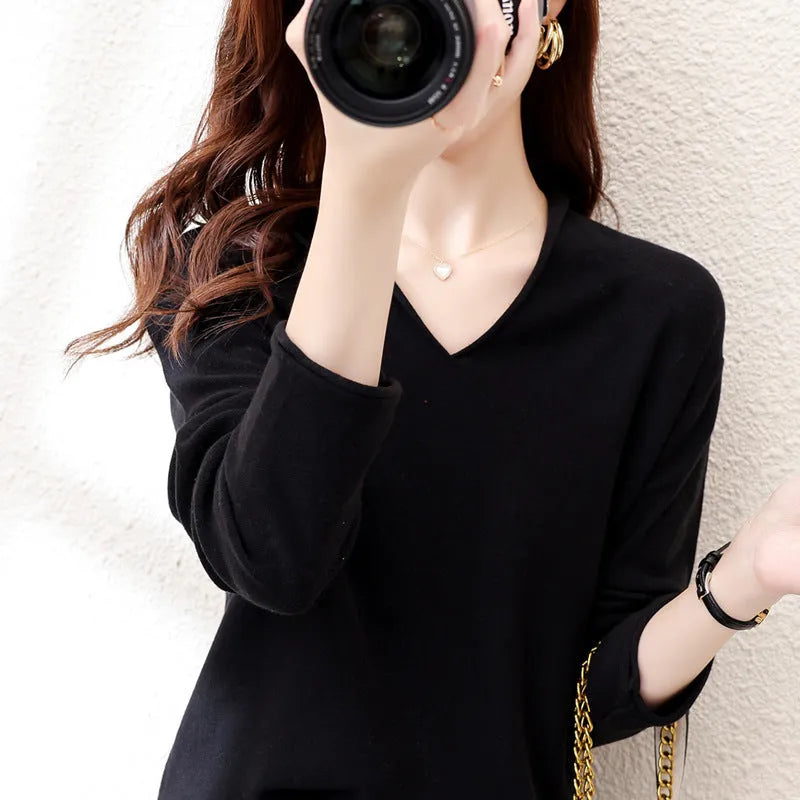 Women's V-neck long sleeve knitwear pullover top in a macaron colour on a hanger.