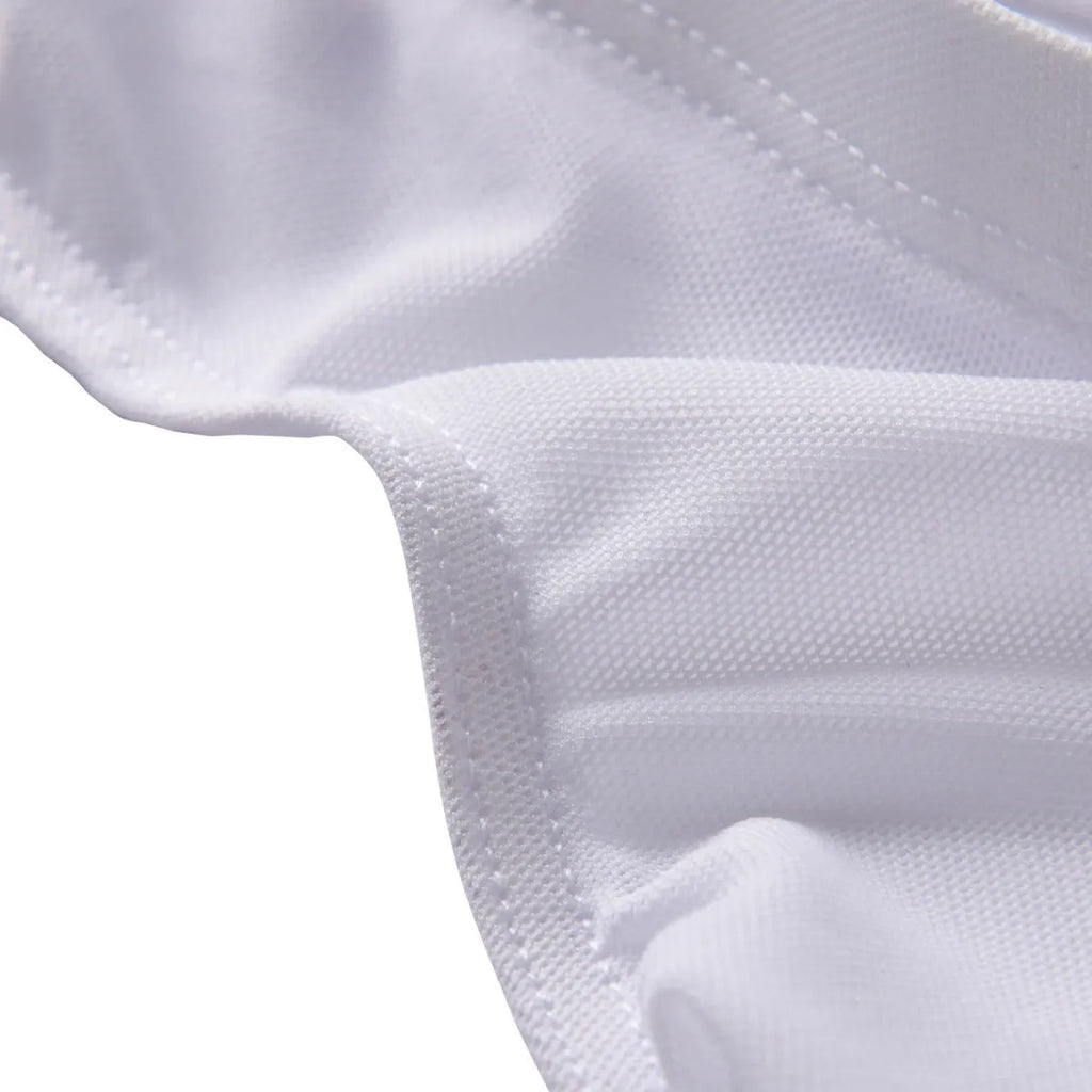 Men's black nylon triangle briefs laid flat, showing mid to low waist design and knitted fabric texture.
