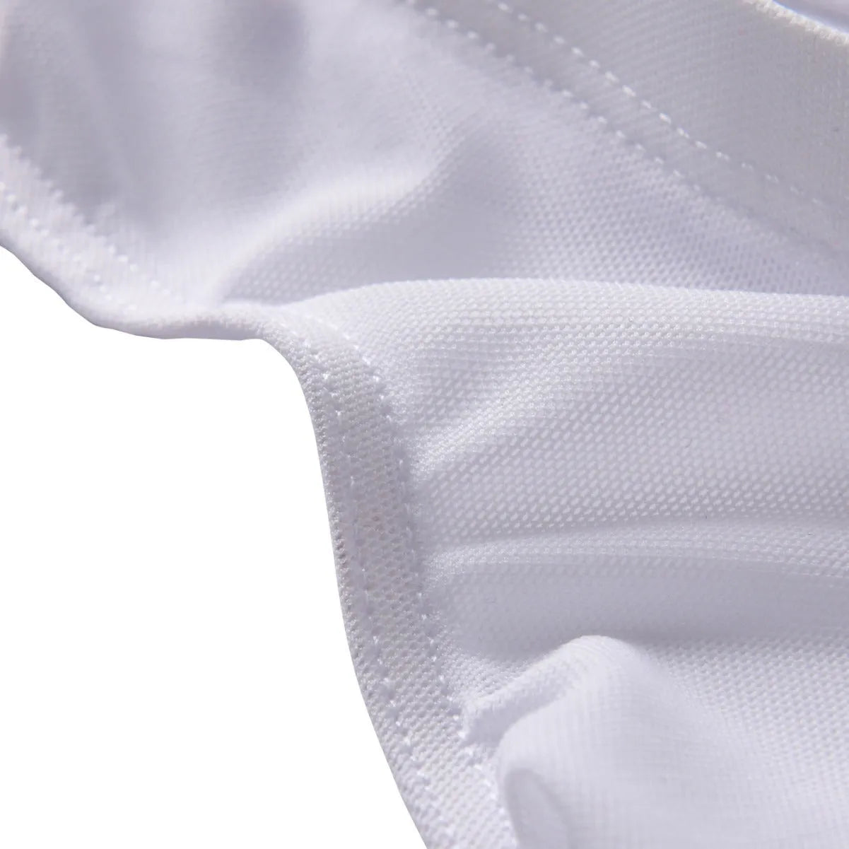 Men's black nylon triangle briefs laid flat, showing mid to low waist design and knitted fabric texture.