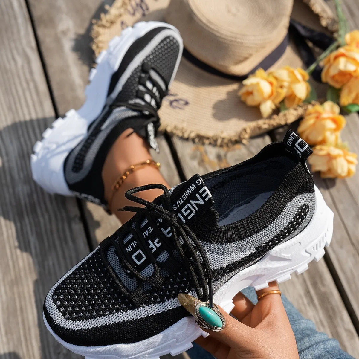 Women's Flyknit mesh lace-up sneaker in a grey colourway, showing the breathable upper and rubber sole.