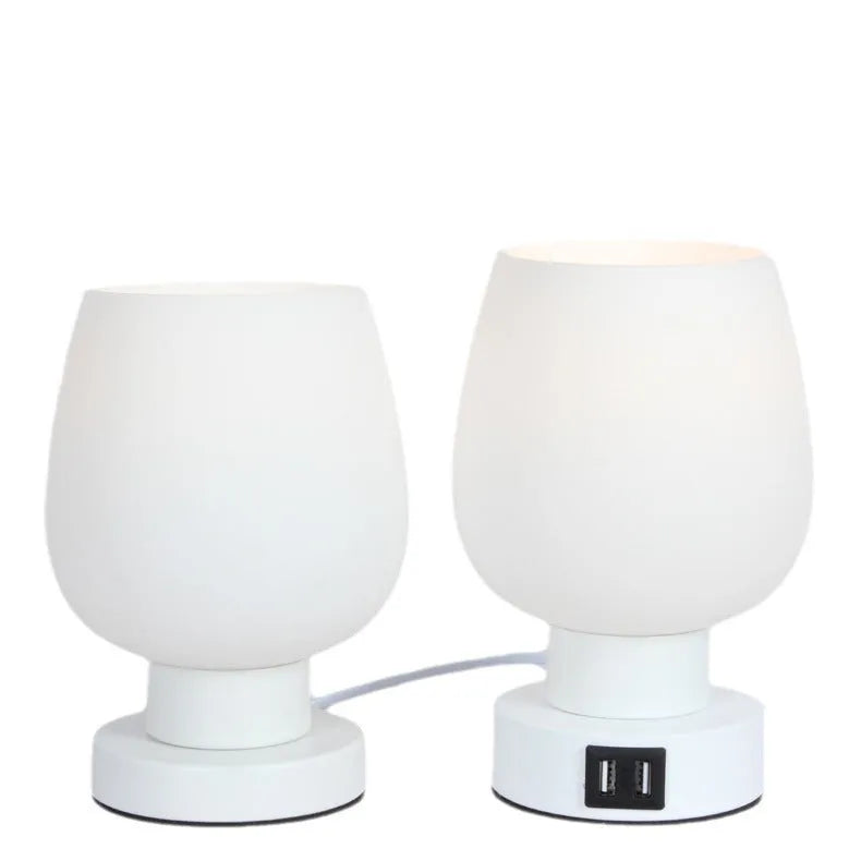 Nordic touch glass desk lamp with three colour settings and USB port on bedside table