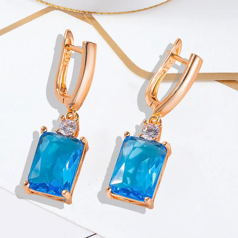 A pair of square geometric stud earrings with a quadrilateral design in an electroplated gold or silver finish.