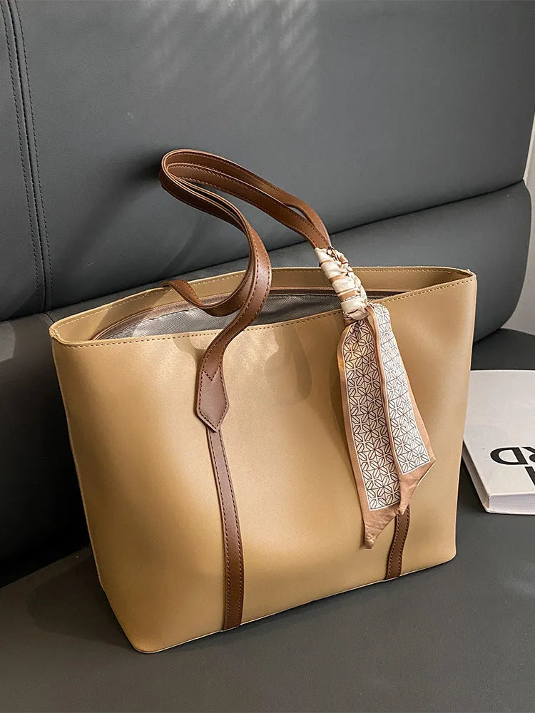 Large casual tote bag with bucket shape showing internal zippered pocket and sewing line detailing