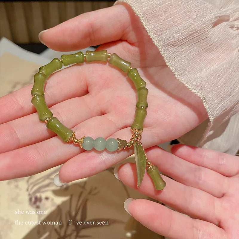 Handmade Chinese style glass bracelet with bamboo joint beads in a red Lvzhu Duobao design.