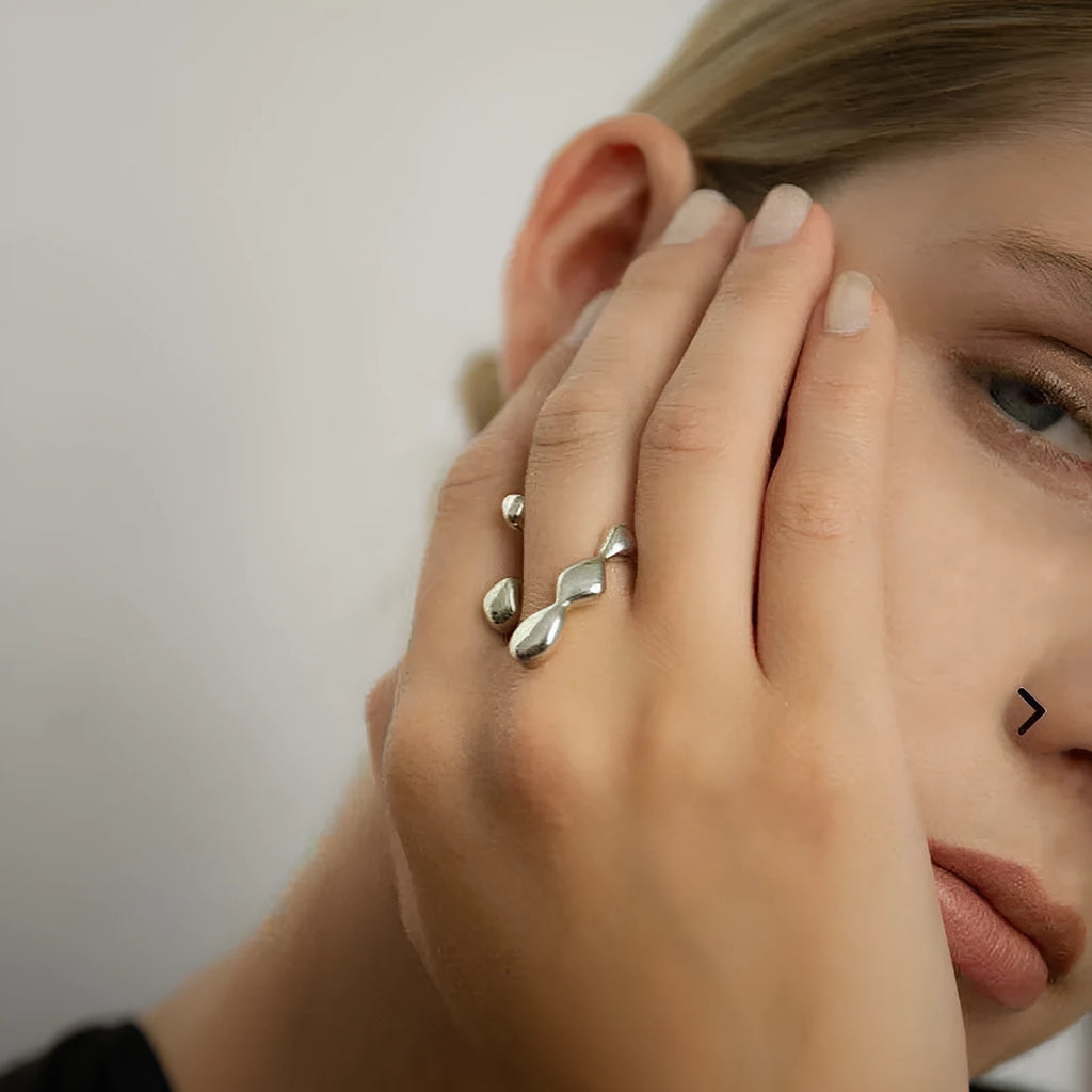 Adjustable brass opening ring with circular sphere element in gold or silver finish