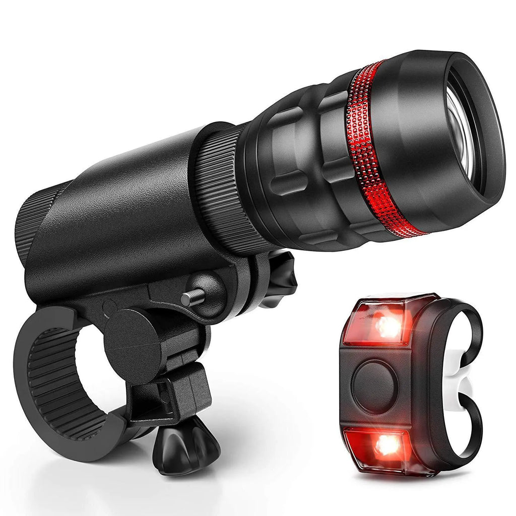 Black bicycle headlight and taillight set with handlebar mounting bracket on a bicycle.