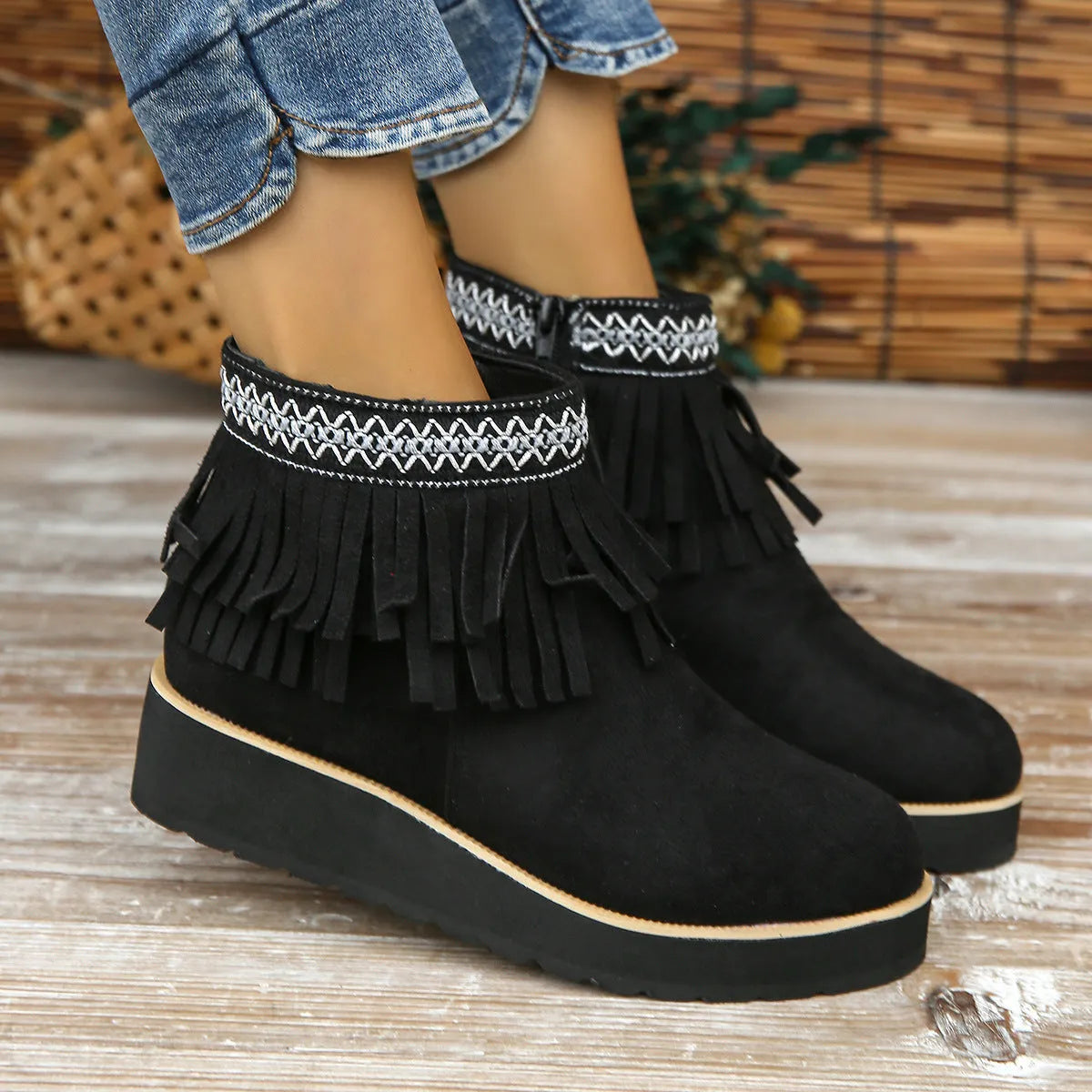 Women's dark brown suede wedge ankle boots with a side zipper and decorative tassel.