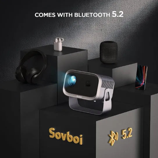 Portable 4K smart projector unit with remote on a wooden table