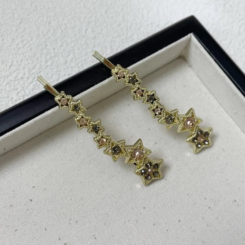 Gold-coloured Korean style hair clip barrette with side clip design and five-pointed star decoration