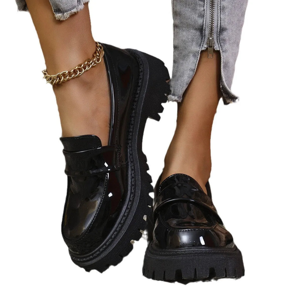 Plus size women's slip-on loafers in black with a chunky platform heel and rubber sole.
