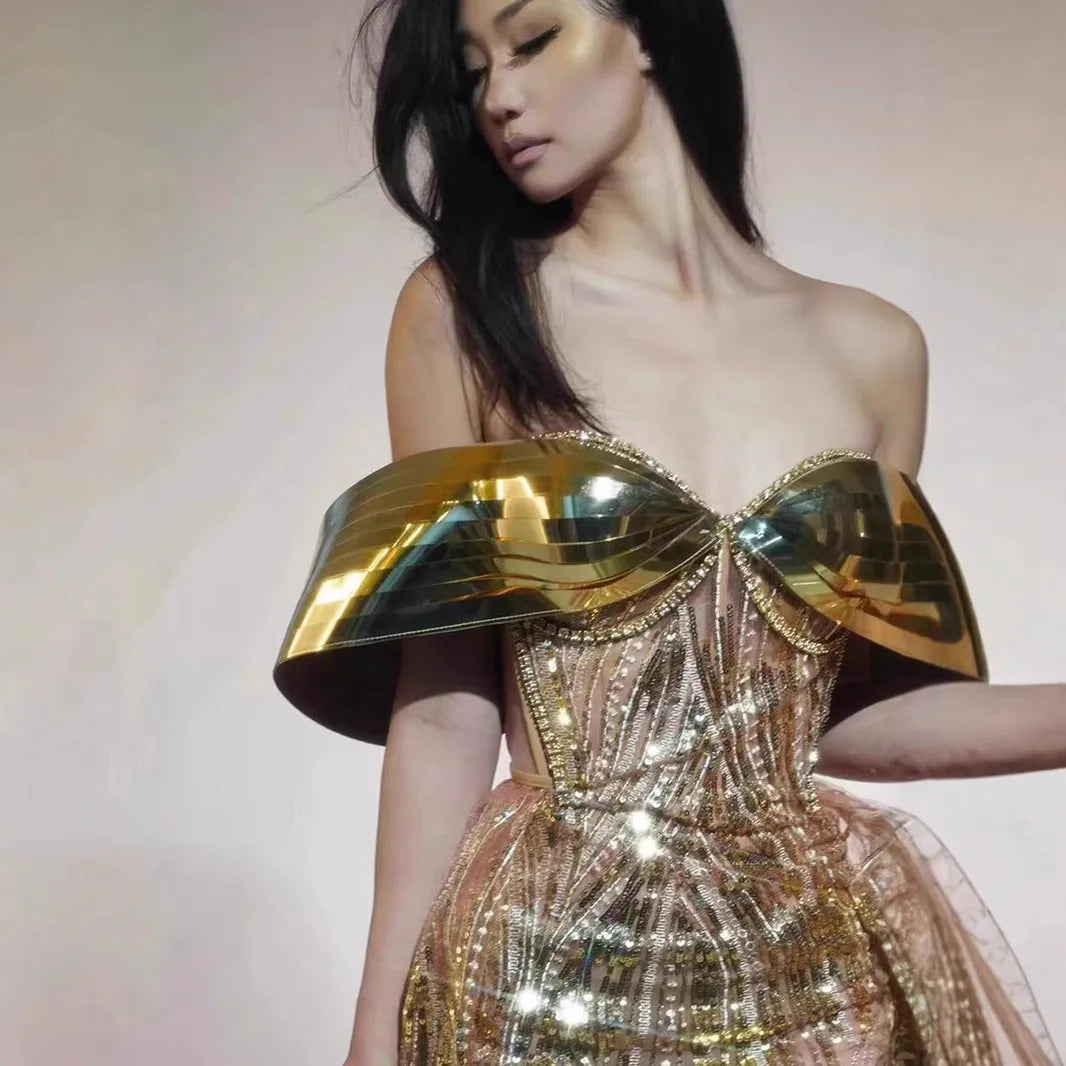 Gold sequined strapless dress with tulle skirt and thigh-high split, shown on mannequin