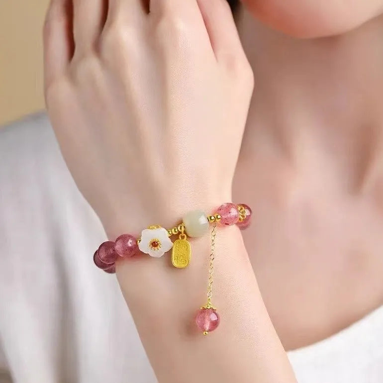 Handmade natural strawberry quartz crystal bracelet for women with moon and pearl bead designs.