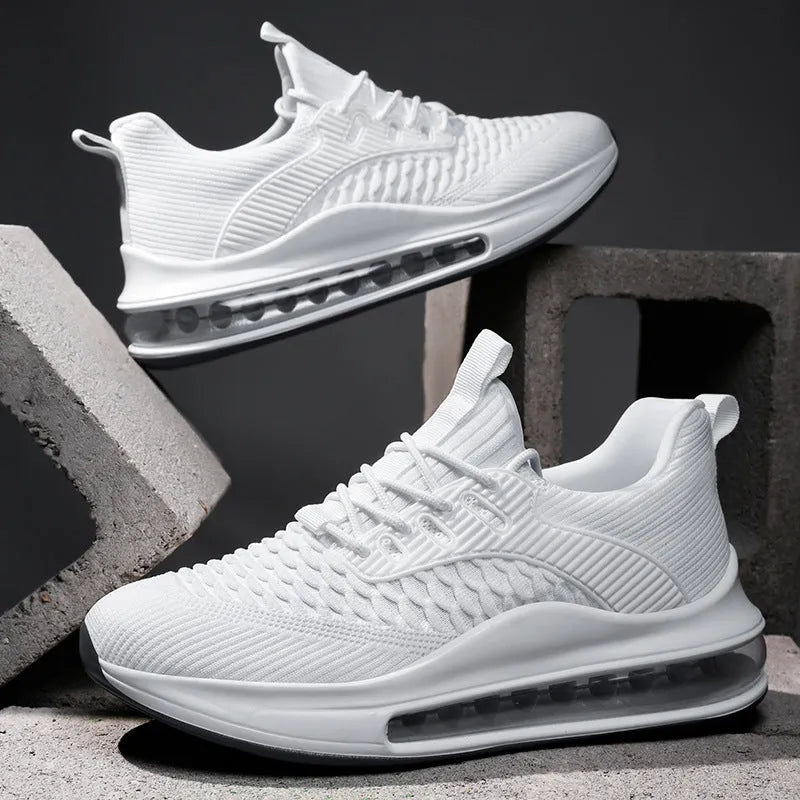 Men's black low-top running shoes with mesh upper and white rubber sole on a plain background.
