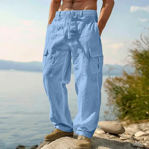 Man wearing light army green loose cotton wide-leg casual trousers with a mid waist.