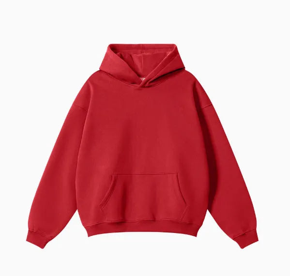 Man wearing a loose-fit grey cotton terry hooded sweater with drop-shoulder sleeves.
