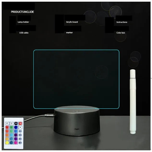 Black 3D acrylic night light with handwritten message board, remote control, and marker pen on desk.