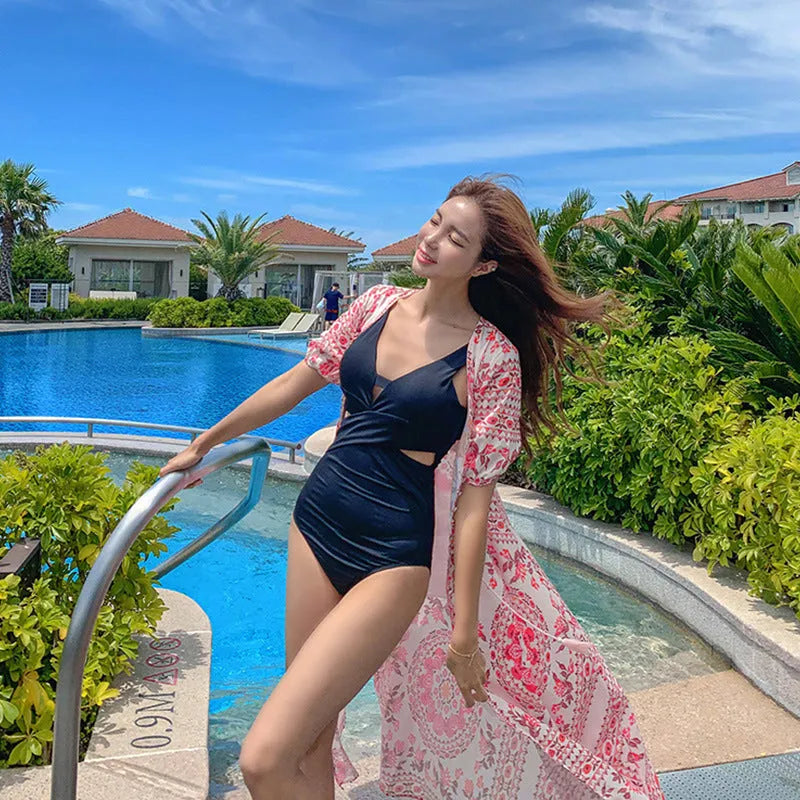 Women's one-piece hollow Siamese cut-out swimsuit in dark blue polyester fabric on model