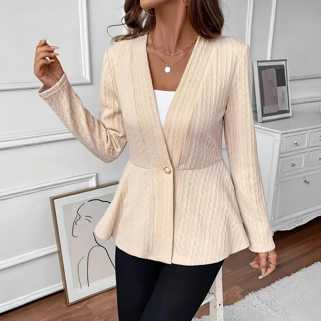 Women's apricot tight-fit Jacquard knitted cardigan with one button on a hanger.