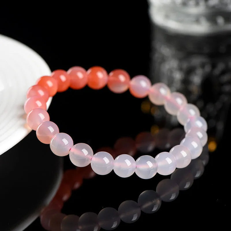 Natural gradient Yanyuan agate bracelet with geometric beads in salt source colour on a white background