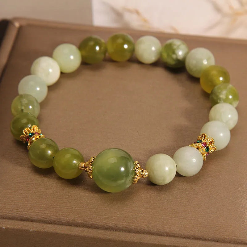 Xiuyan jade green Mori-style women's bracelet on a wrist.