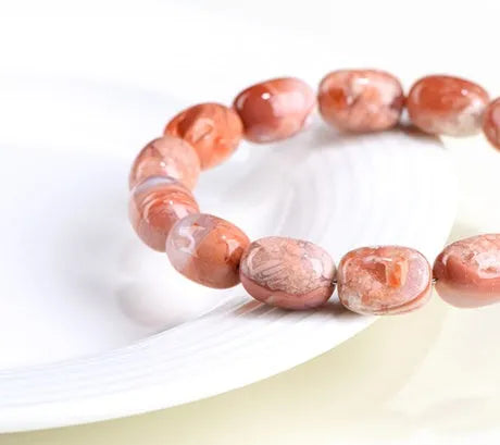 Natural cherry blossom agate barrel bead bracelet with 10mm by 14mm geometry design and ruyi element
